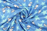 Jumping Snoopy Over Stars on Printed Blue Flannelette