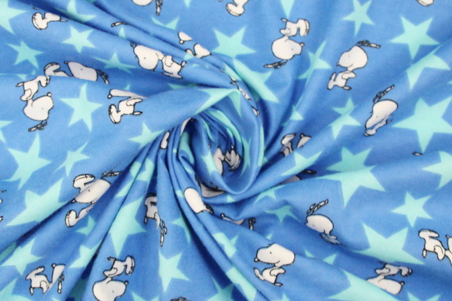 Jumping Snoopy Over Stars on Printed Blue Flannelette