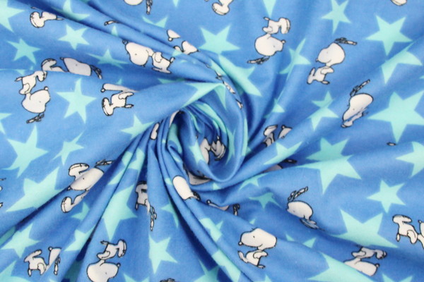 Jumping Snoopy Over Stars on Printed Blue Flannelette