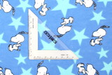 Jumping Snoopy Over Stars on Printed Blue Flannelette